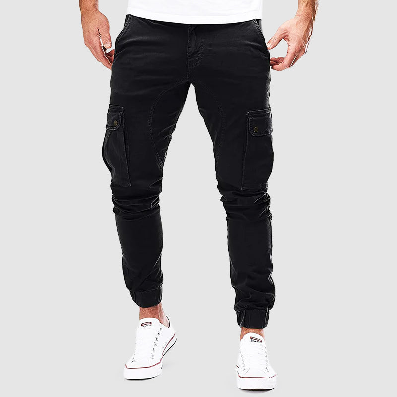 Men's FJØRNA cargo pants in cotton, slim fit style with multiple front and back pockets, designed for comfort and practical wear.