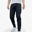 Men's FJØRNA cargo pants with stretch fabric and multiple front and back pockets, designed for comfort and durability.