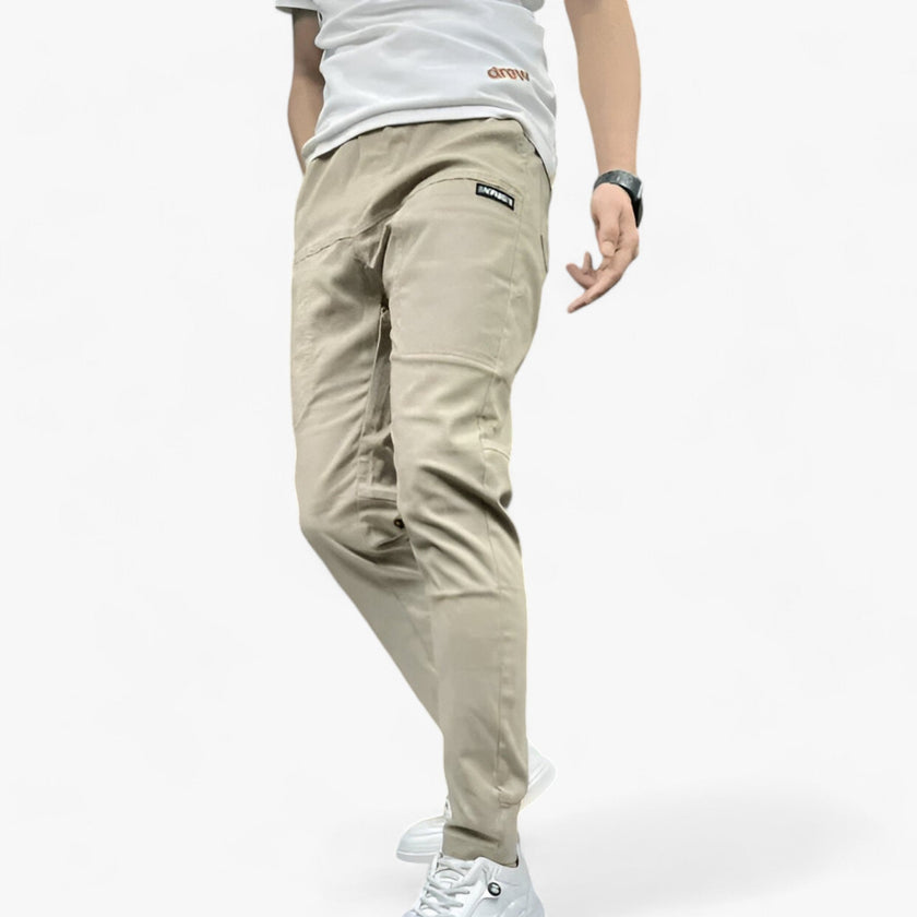 Men's FJØRNA cargo pants with stretch fabric and multiple pockets, shown in a casual style perfect for outdoor and everyday wear.