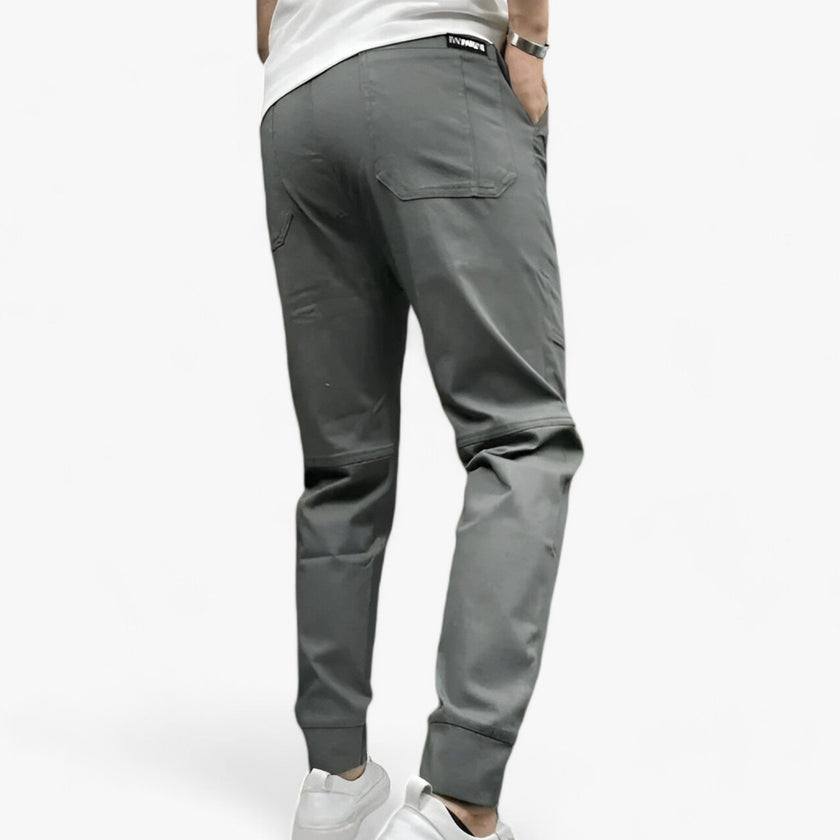 Men's FJØRNA cargo pants with stretch fabric and multiple functional pockets, designed for comfort and utility.