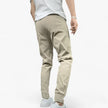 Men's stretch cargo pants with multiple pockets, casual fit, by FJØRNA, shown in a neutral color and relaxed style.