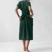 FJØRNA elegant women's midi dress with V-neck and short sleeves, stylish and suitable for casual or formal occasions.