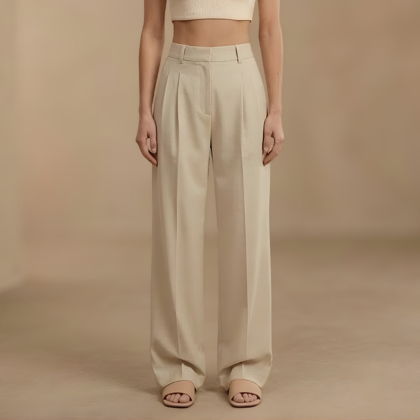 FJØRNA high-waist pleated wide-leg women's trousers displayed on a hanger, showcasing their flowy fabric and tailored fit.