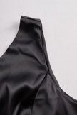 FJØRNA Glamorous Allure black one-shoulder maxi dress displayed on a hanger, showcasing elegant design and flowing fabric.