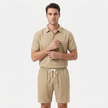 Men's linen short sleeve polo shirt and shorts set by FJØRNA, lightweight and stylish for warm weather, shown in a casual outdoor setting.