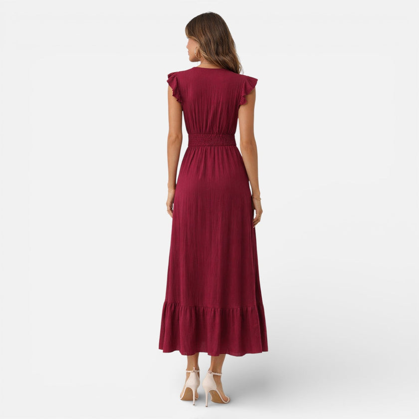 FJØRNA women's sleeveless maxi dress with a flowy fit and timeless style, shown in a natural, elegant pose.