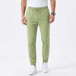FJØRNA men's stretchable comfort trousers with a slim fit design, shown in a neutral color, featuring a classic waistband and front pockets.