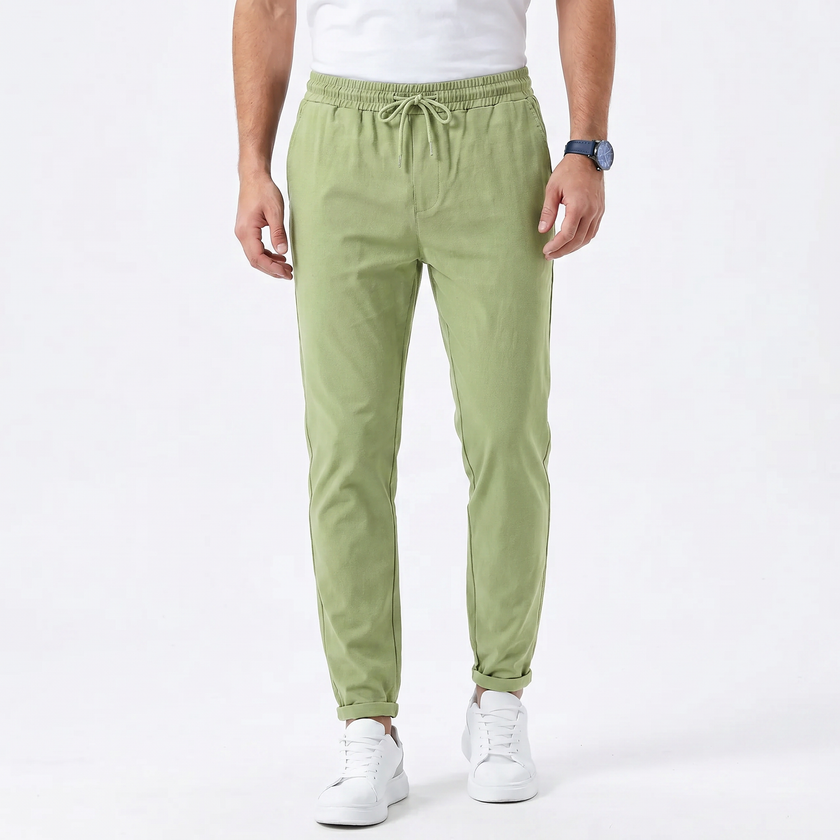 FJØRNA men's stretchable comfort trousers with a slim fit design, shown in a neutral color, featuring a classic waistband and front pockets.