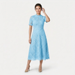 Women's FJØRNA elegant lace midi dress featuring a high neck and refined cutwork detail, showcasing a sophisticated silhouette.