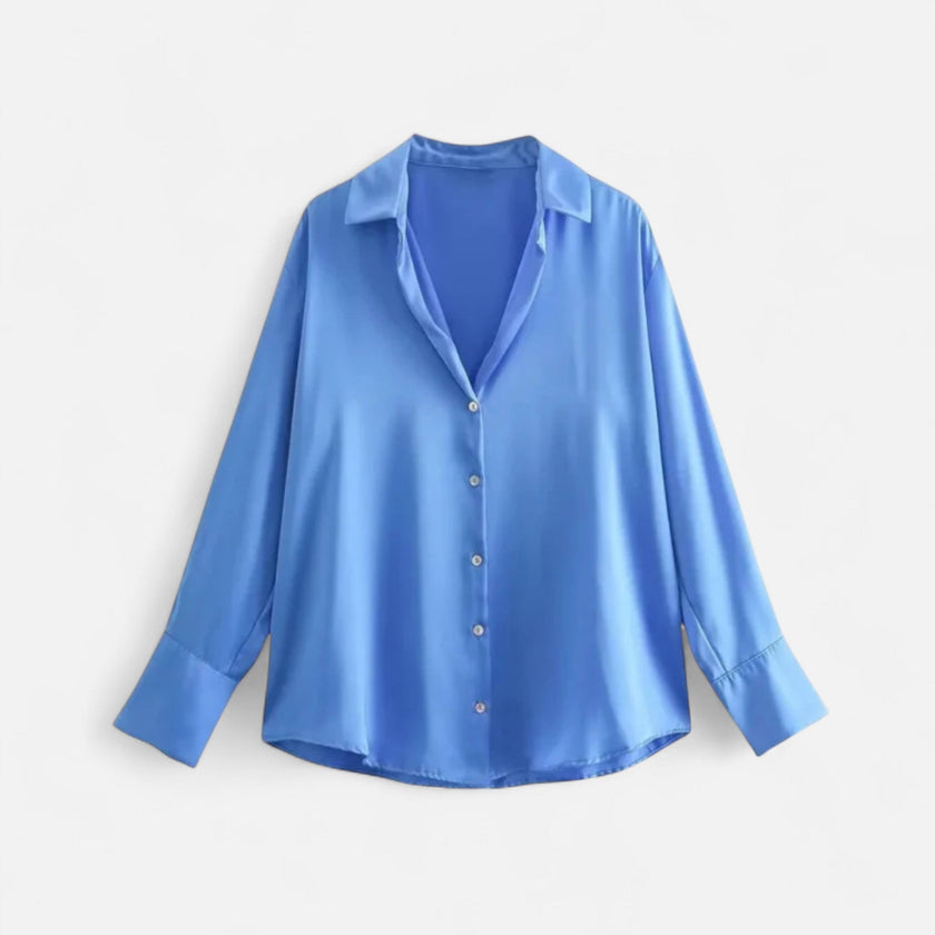 FJØRNA women's button-front long sleeve blouse in classic fit, featuring a tailored design and soft fabric in a natural pose.