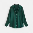 FJØRNA women's button-front long sleeve blouse in classic fit, featuring a smooth fabric and tailored design, shown on a hanger.