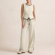 Ivory white FJØRNA two-piece set with contrast trim, featuring relaxed wide-leg pants and a matching top.