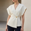 Ivory FJØRNA women's fitted wrap-front V-neck blouse with sculpted waist and embellishment, showcasing elegant, tailored design.