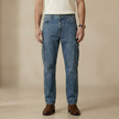 Light blue men's tapered jeans with elastic waist from FJØRNA, casual pants with ankle fit and comfortable stretch.