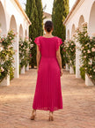 Elegant FJØRNA mini dress for women featuring pleated design, perfect for evening wear, shown on a model.