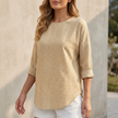 Khaki relaxed-fit women's blouse by FJØRNA with rolled sleeves and a curved hem, displayed on a mannequin.