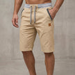 Men's FJØRNA relaxed-fit work shorts in khaki, tailored design with pockets and a casual, comfortable fit.