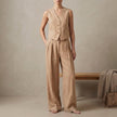FJØRNA khaki sleeveless linen vest and high-waisted pleated trouser set on a model, showcasing stylish tailored summer outfit.