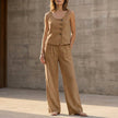 FJØRNA khaki sleeveless two-piece set with decorative buttons and wide-leg trousers, casual and stylish for warm weather.