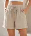 Khaki women's summer linen shorts with pockets and drawstring from FJØRNA, casual and comfortable for warm weather.