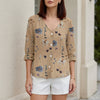 FJØRNA women's summer blouse with floral pattern, V-neck, khaki denim fabric, button front, stylish women's top.