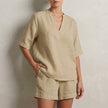 Khaki summer two-piece women's co-ord set by FJØRNA with V-neck top and pocket details, casual and stylish for warm weather.