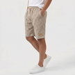 FJØRNA men's khaki linen shorts with elasticated waist and drawstring, shown from side view, perfect for summer beachwear.