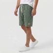 Men's khaki linen shorts with elastic waistband and drawstring, shown from the side, suitable for summer beachwear by FJØRNA.