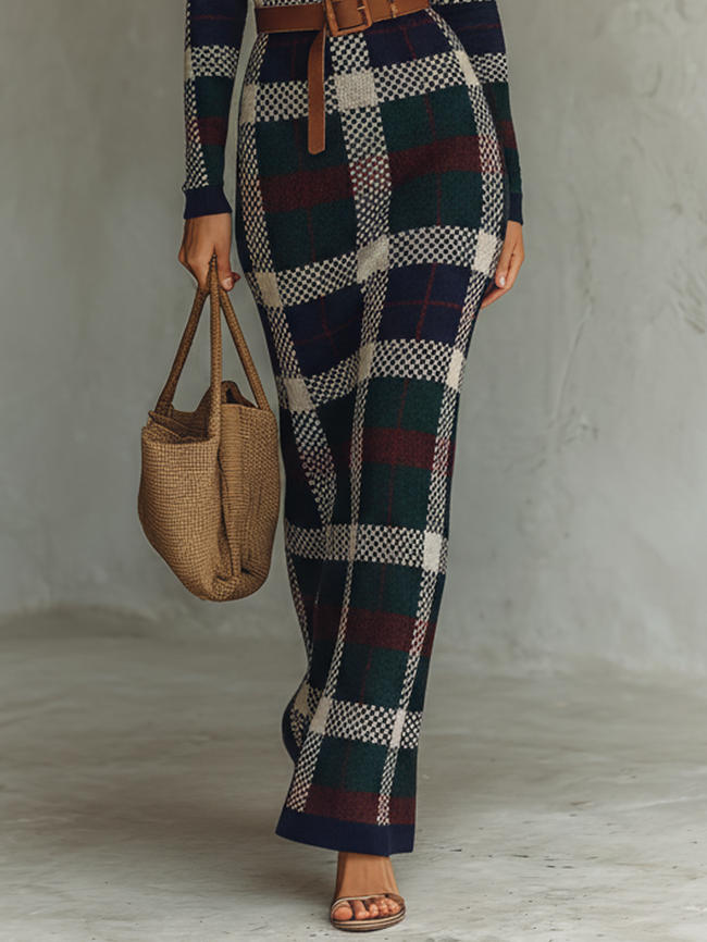 FJØRNA women's knit maxi dress displayed on a model, featuring a flowing silhouette and long sleeves in soft knit fabric.