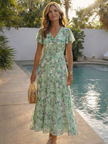 Floral summer maxi dress for women by FJØRNA featuring flutter sleeves and a flowing, lightweight design.