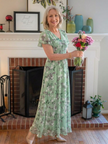 Floral summer maxi dress for women by FJØRNA featuring flutter sleeves and a flowing, lightweight design.