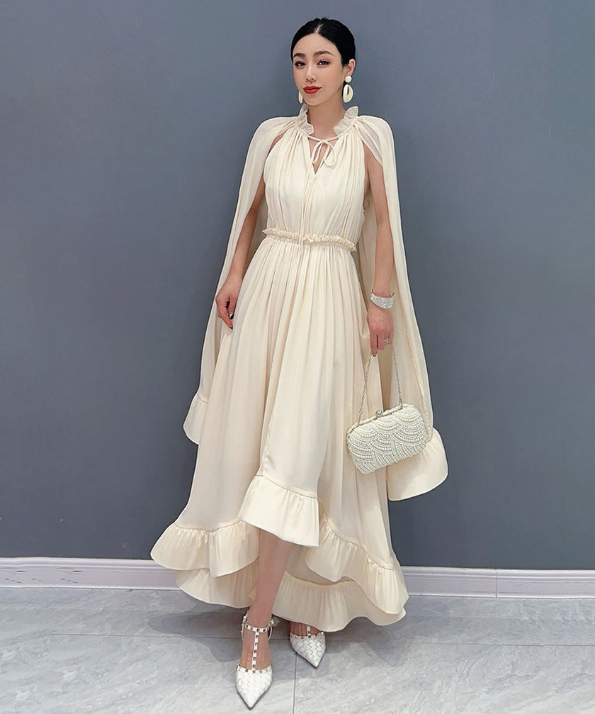 FJØRNA Veil Flow White Dress displayed on a model, showcasing its flowing fabric and elegant design.