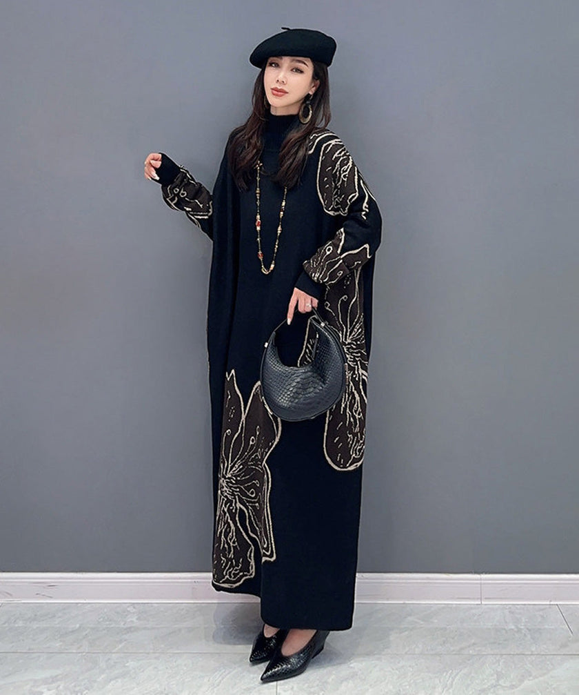 White floral motif knit long dress by FJØRNA featuring a fitted bodice and flowing skirt with intricate floral patterns.