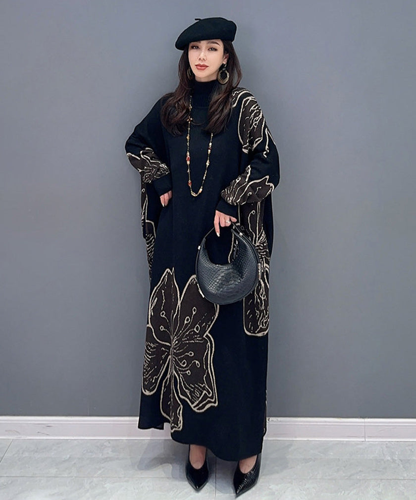 White floral motif knit long dress by FJØRNA, featuring intricate floral patterns and a flowing, elegant silhouette.