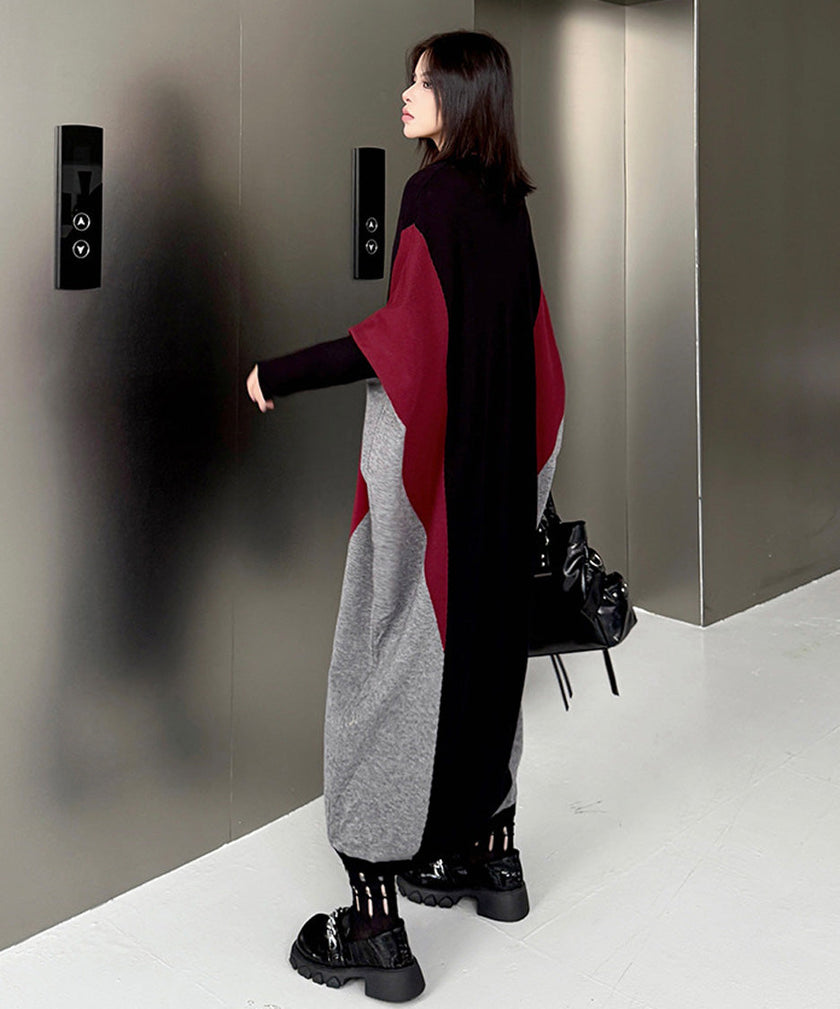 FJØRNA white panel knit long dress displayed on a hanger, showcasing its elegant, fitted design and soft knit texture.