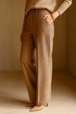 Close-up of FJØRNA wool blend trousers for women, showing detailed fabric texture and tailored fit.