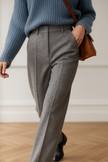 FJØRNA women's wool blend trousers styled with a tailored fit, featuring a classic waistband and side pockets.
