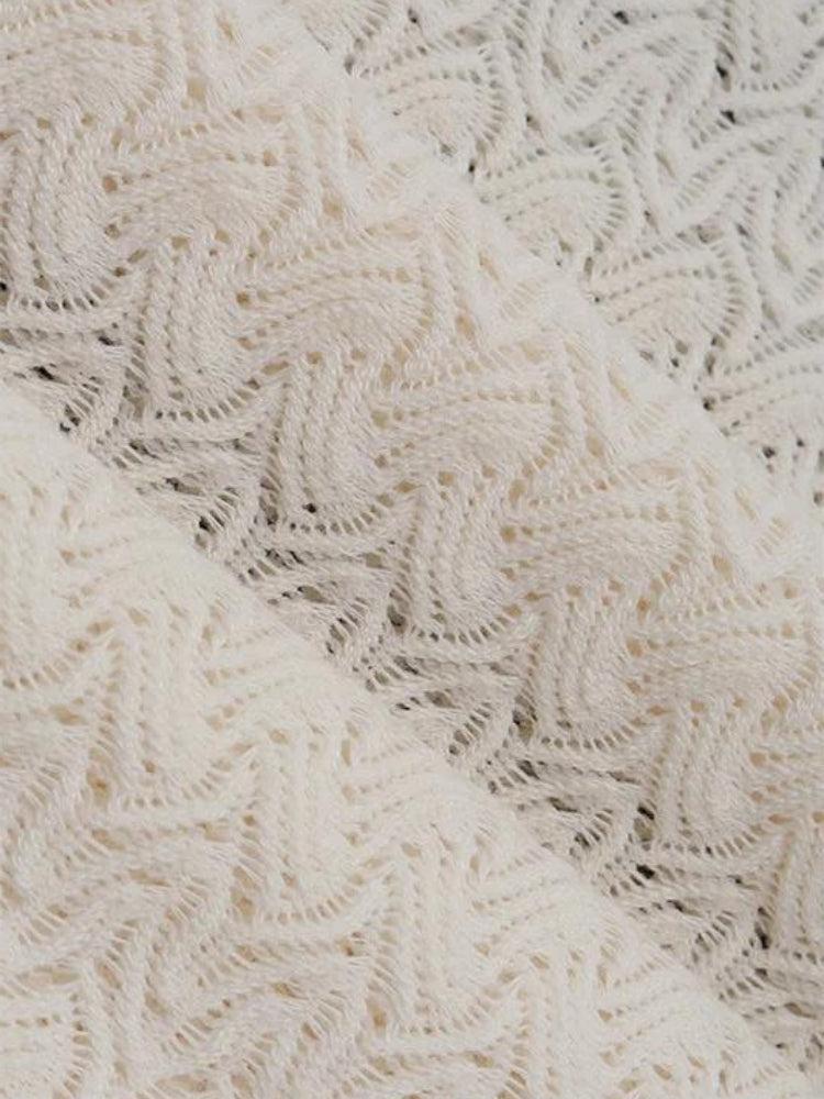 White lace-backless plunge neck maxi dress by FJØRNA, showcasing elegant design with delicate lace details and flowing fabric.
