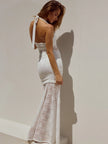FJØRNA lace maxi dress with intricate floral lace design, floor-length gown featuring elegant long sleeves and a fitted waist.