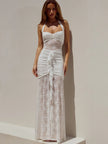 FJØRNA lace maxi dress worn by a model, flowing floor-length dress with intricate lace details, elegant and lightweight fabric.