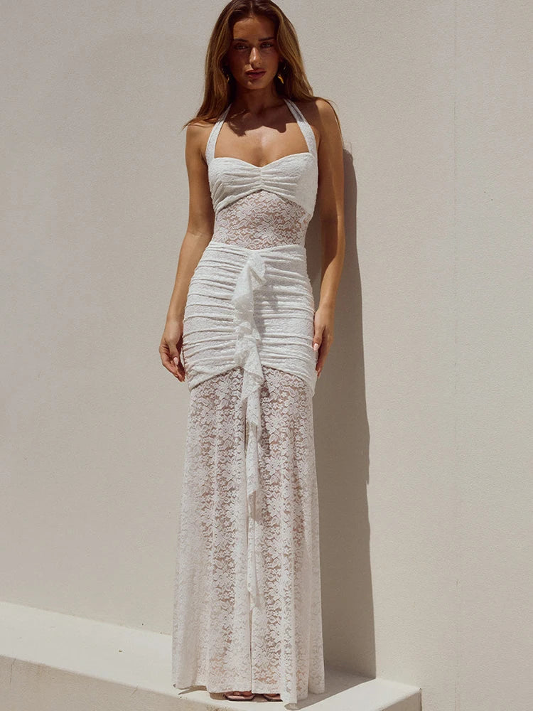 FJØRNA lace maxi dress worn by a model, flowing floor-length dress with intricate lace details, elegant and lightweight fabric.