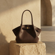 FJØRNA Leather medium work tote bag with handles, spacious design, and sleek brown leather for everyday use.
