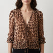 FJØRNA women's summer blouse with V-neck and long sleeves, denim fabric, featuring a leopard print pattern.