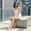 FJØRNA ruffle strap sleeveless top and shorts lounge set, casual 2-piece outfit with ruffle details, laid on a relaxed living space.