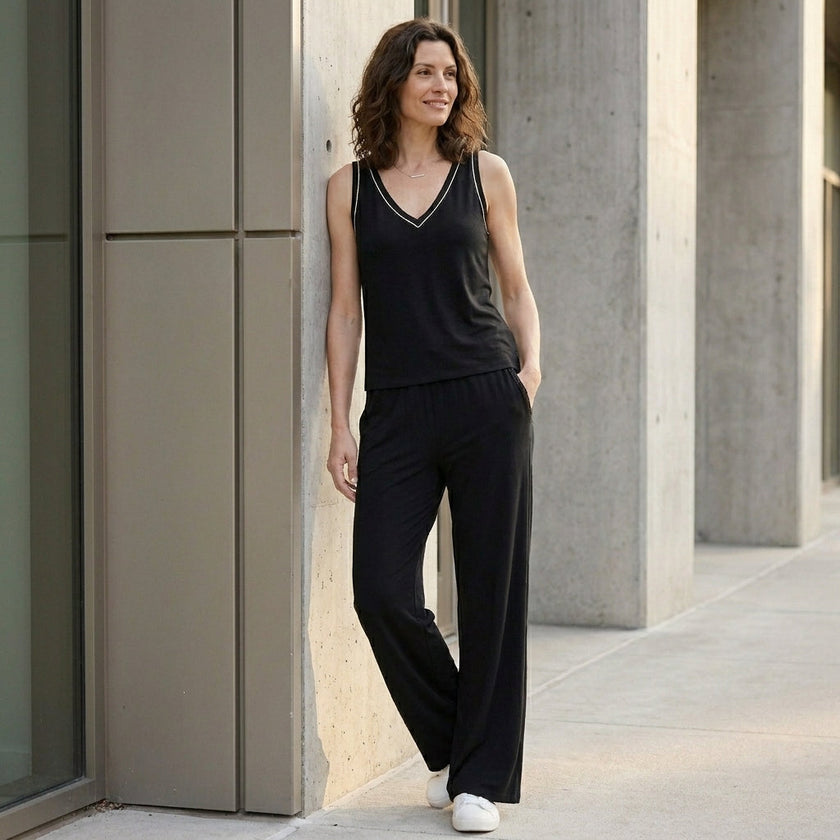 FJØRNA relaxed v-neck sleeveless lounge set with wide-leg pants, styled in a cozy, casual indoor setting.
