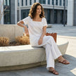 FJØRNA Coastal Breeze relaxed top and wide-leg pant set worn by a model in a casual outdoor setting.