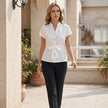FJØRNA women's summer cap sleeve denim blouse worn casually, showcasing relaxed fit and stylish design for warm weather.