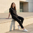 Women wearing FJØRNA summer short sleeve denim blouse, casual lifestyle shot showcasing the relaxed fit and stylish design.