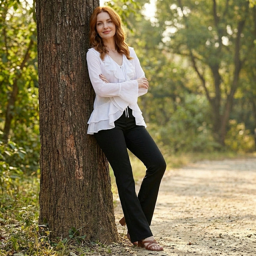 FJØRNA women's summer blouse with bell sleeves, denim fabric, casual top for warm weather, styled in a relaxed outdoor setting