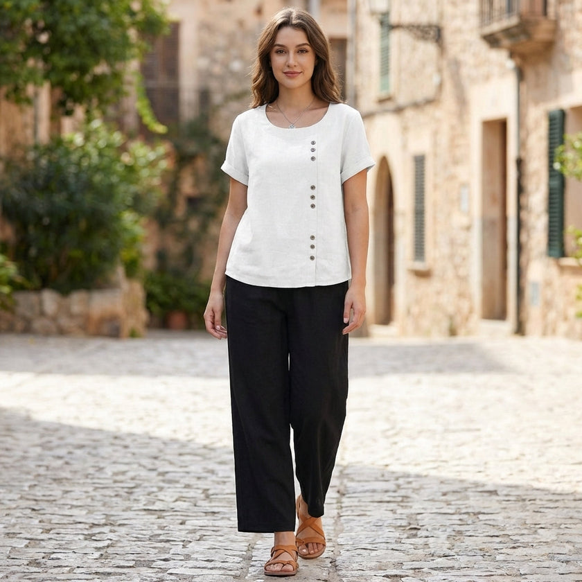 Relaxed linen blouse for women with asymmetric detail, styled casually for daytime wear, by FJØRNA.